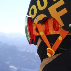 A rider wearing an Out Of Earth ski goggle under his wipeout helmet