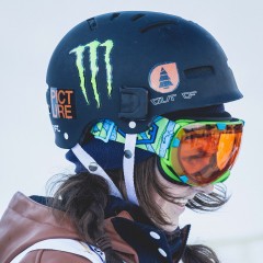 A girl wearing an Out Of Eyes ski goggle under his Wipeout helmet